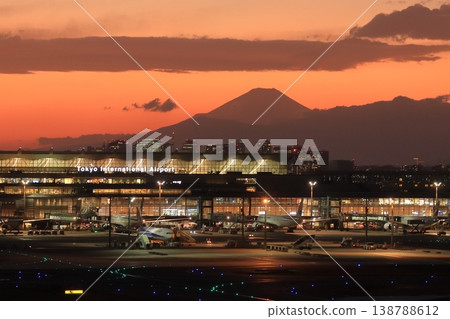 A night view of Haneda Airport with Mount Fuji silhouetted against the sunset. A night view of Haneda Airport with Mount Fuji silhouetted against the sunset. 138788612