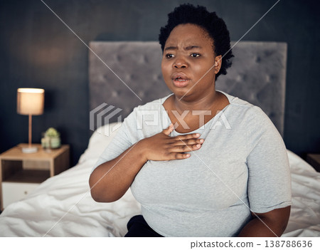 Fear, sick and a black woman with an anxiety attack or pain in chest from stress. Scary, health and an African girl on a bed with panic, depression or a mental health illness or fail in the bedroom 138788636