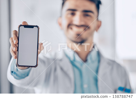 Happy man, doctor and phone mockup screen for healthcare advertising or marketing at the hospital. Male person or medical professional show mobile smartphone display for Telehealth or app at clinic 138788747
