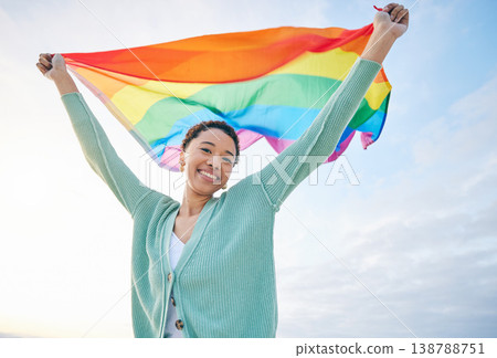 Woman, outdoor and rainbow pride flag in portrait with smile, wind and wave for lgbtq, inclusion and equality. African girl, fabric or cloth for human rights, lesbian sexuality and happy on vacation 138788751
