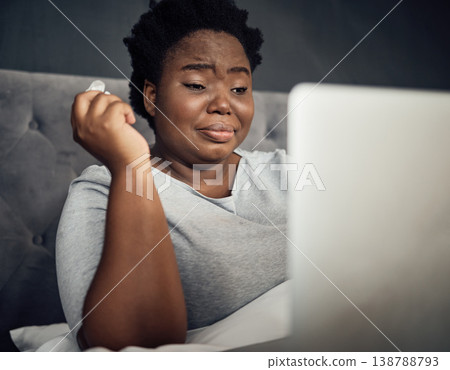 Sad, crying and a black woman with a laptop in bed for a movie, film or show in a house. Depression, technology and an African person with a computer for an online drama or social media notification Sad, crying and a black woman with a laptop in bed for a movie, film or show in a house. Depression, technology and an African person with a computer for an online drama or social media notification 138788793