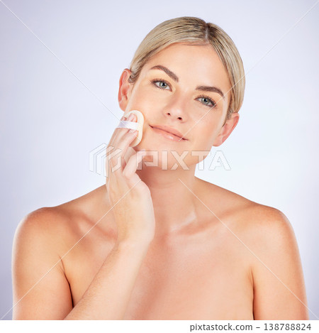 Skincare, portrait and woman with makeup pad in studio for cometic, powder or application on grey background. Face, wellness and female model with beauty sponge for blend, contour or skin baking Skincare, portrait and woman with makeup pad in studio for cometic, powder or application on grey background. Face, wellness and female model with beauty sponge for blend, contour or skin baking 138788824