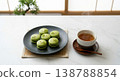 A set of luxurious matcha macarons and warm tea, evoking a modern Japanese teatime image. 138788854