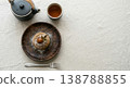 A set featuring Mont Blanc, a taste of autumn, and warm tea, presented on a wooden plate and in a teapot, evoking the image of a traditional tea time. 138788855