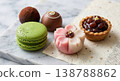A luxurious assortment of Japanese modern sweets, including matcha macarons and flower-shaped nerikiri (traditional Japanese confectionery). 138788862