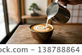 A scene of latte art being made by pouring coffee into a Japanese-style cup. A modern Japanese cafe image featuring bonsai trees and shoji screens. 138788864