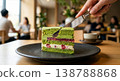Enjoy a matcha and berry cake in a modern Japanese-style cafe; the moment you cut into it, the mouthwatering effect is enhanced. 138788868