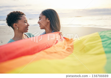 Pride flag, lesbian couple and freedom smile at beach for romance, happy or care in nature. Rainbow, love and women at ocean embrace lgbt, gay or partner pride, date or romantic relationship moment Pride flag, lesbian couple and freedom smile at beach for romance, happy or care in nature. Rainbow, love and women at ocean embrace lgbt, gay or partner pride, date or romantic relationship moment 138788889