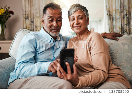 Senior couple, phone and reading on home sofa with internet connection, network and love. Mature man and woman relax together on a couch with smartphone for streaming and online news or social media Senior couple, phone and reading on home sofa with internet connection, network and love. Mature man and woman relax together on a couch with smartphone for streaming and online news or social media 138788900