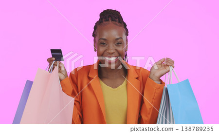 Woman, portrait and credit card with shopping bag for financial success, sale and discount on pink background. Excited customer or african winner in celebration for banking, fashion or gift in studio Woman, portrait and credit card with shopping bag for financial success, sale and discount on pink background. Excited customer or african winner in celebration for banking, fashion or gift in studio 138789235