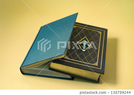 A stack of heard cover bible on color background. 138789244