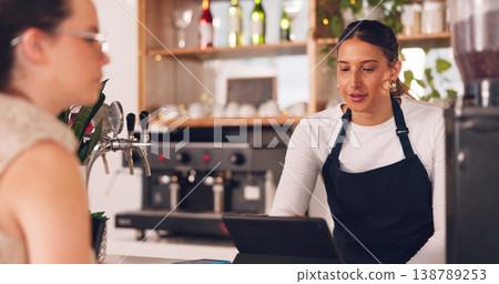Women, barista or customer order at cafe for service, payment or order on counter at coffee shop. Serving, waitress or employee in small business restaurant helping a girl client at checkout or work Women, barista or customer order at cafe for service, payment or order on counter at coffee shop. Serving, waitress or employee in small business restaurant helping a girl client at checkout or work 138789253