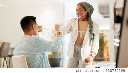 Fist bump, excited and business people in an office for success, celebration or teamwork. Happy, collaboration and a Muslim employee with a man for a thank you, partnership or friends handshake Fist bump, excited and business people in an office for success, celebration or teamwork. Happy, collaboration and a Muslim employee with a man for a thank you, partnership or friends handshake 138789269