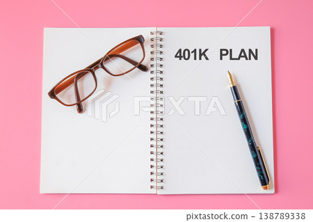 A message 401K Plan text written on note page with pencil and eyeglasses. 138789338
