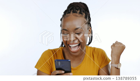 Phone, black woman and happy fist for success, celebration or achievement and winner for giveaway in studio on white background. Excited, prize and person with smartphone celebrate winning lottery 138789355
