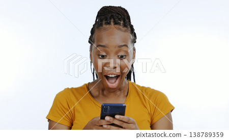 Woman, smartphone or winner notification with surprise on technology, gen z aesthetic and white background. Black person, smile or digital news on mobile, competition announcement and studio mockup Woman, smartphone or winner notification with surprise on technology, gen z aesthetic and white background. Black person, smile or digital news on mobile, competition announcement and studio mockup 138789359