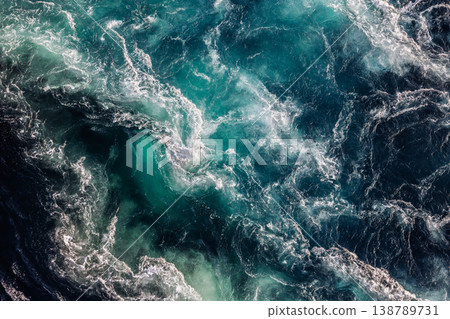 Blue waves of water of the river and the sea meet each other during high tide and low tide. Blue waves of water of the river and the sea meet each other during high tide and low tide. 138789731