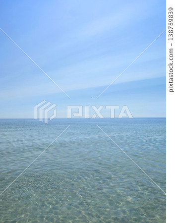 Seascape. Sea Smooth surface of the blue sea and blue sky. Abstract sea view scenery. Sea landscape. Skyline. Nature backdrop. Natural background. Nobody. Sun glare. Calm sunny weather. Small waves 138789839