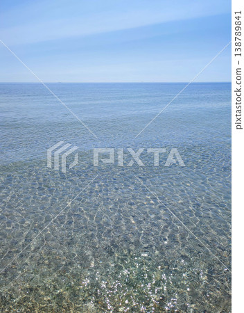Seascape. Sea Smooth surface of the blue sea and blue sky. Abstract sea view scenery. Sea landscape. Skyline. Nature backdrop. Natural background. Nobody. Sun glare. Calm sunny weather. Small waves Seascape. Sea Smooth surface of the blue sea and blue sky. Abstract sea view scenery. Sea landscape. Skyline. Nature backdrop. Natural background. Nobody. Sun glare. Calm sunny weather. Small waves 138789841