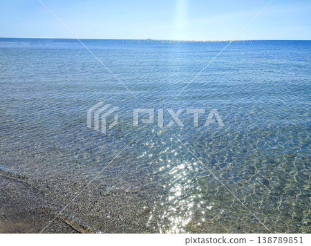 Seascape. Sea Smooth surface of the blue sea and blue sky. Abstract sea view scenery. Sea landscape. Skyline. Nature backdrop. Natural background. Nobody. Sun glare. Calm sunny weather. Small waves Seascape. Sea Smooth surface of the blue sea and blue sky. Abstract sea view scenery. Sea landscape. Skyline. Nature backdrop. Natural background. Nobody. Sun glare. Calm sunny weather. Small waves 138789851