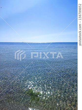 Seascape. Sea Smooth surface of the blue sea and blue sky. Abstract sea view scenery. Sea landscape. Skyline. Nature backdrop. Natural background. Nobody. Sun glare. Calm sunny weather. Small waves Seascape. Sea Smooth surface of the blue sea and blue sky. Abstract sea view scenery. Sea landscape. Skyline. Nature backdrop. Natural background. Nobody. Sun glare. Calm sunny weather. Small waves 138789852