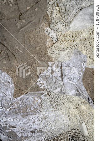 Close up of vintage lace fabric white on black background embroidery Close up of vintage lace fabric white on black background embroidery 138789918