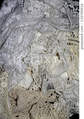 Close up of vintage lace fabric white on black background embroidery Close up of vintage lace fabric white on black background embroidery 138789919