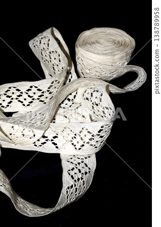 Close up of vintage lace fabric white on black background embroidery Close up of vintage lace fabric white on black background embroidery 138789958