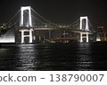 The illuminated Rainbow Bridge and the view of Tokyo Bay at night. 138790007