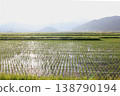 Spreading rice paddies and hazy mountain ranges 138790194