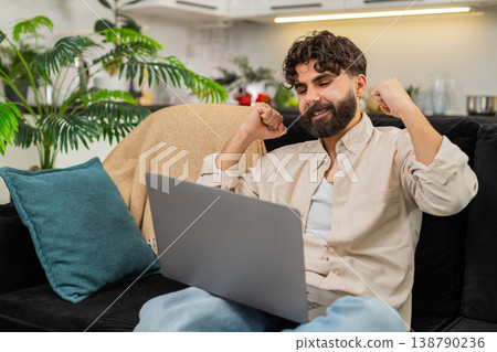 Indian man freelance laptop worker finishing project gets online payment success happy bonus reward Indian man freelance laptop worker finishing project gets online payment success happy bonus reward 138790236