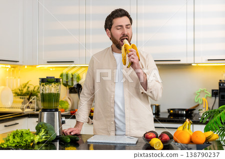 Middle-aged man peeling banana in home kitchen enjoying healthy snack for diet and fitness lifestyle Middle-aged man peeling banana in home kitchen enjoying healthy snack for diet and fitness lifestyle 138790237