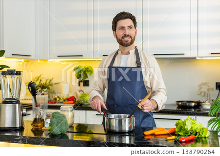 Middle-aged man cooking healthy soup on electric stove in home kitchen for clean diet lifestyle meal Middle-aged man cooking healthy soup on electric stove in home kitchen for clean diet lifestyle meal 138790264