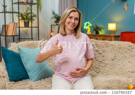Pregnant woman giving thumbs up showing like approval positive feedback happy satisfied warm gesture Pregnant woman giving thumbs up showing like approval positive feedback happy satisfied warm gesture 138790387