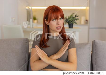 Young woman waves hands to camera disagrees rejects request shows disappointment disapproval firmly Young woman waves hands to camera disagrees rejects request shows disappointment disapproval firmly 138790813