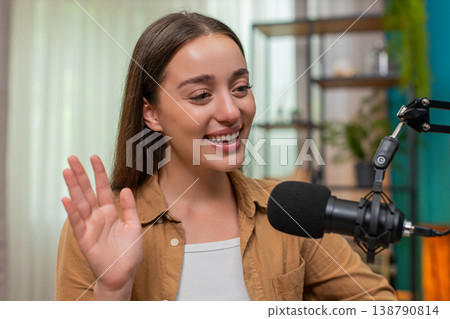 Young woman delivering live lecture on laptop explaining complex topic clearly to global audience Young woman delivering live lecture on laptop explaining complex topic clearly to global audience 138790814
