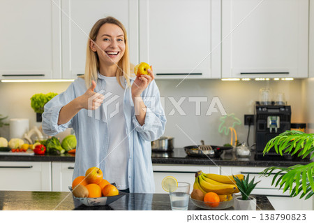 Young woman eating fresh apple in home kitchen enjoying healthy vitamins and nutrition fit lifestyle Young woman eating fresh apple in home kitchen enjoying healthy vitamins and nutrition fit lifestyle 138790823