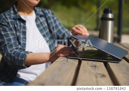 Close up of laptop on wooden table outdoors Close up of laptop on wooden table outdoors 138791842