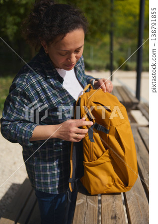 Woman standing with backpack after outdoor remote work Woman standing with backpack after outdoor remote work 138791855
