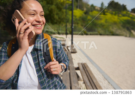Woman using smartphone smiling outdoors Woman using smartphone smiling outdoors 138791863