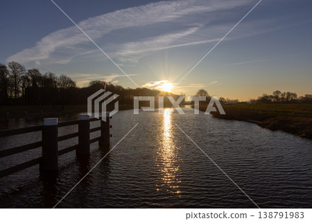 Sunrise on a February morning at river the IJssel in the Achterhoek. Photo taken in Laag-Keppel in the Netherlands. 138791983