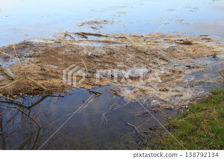 Environmental pollution of a lake bank with plastic waste and chemical foam. Ecological disaster concept showing industrial 138792134