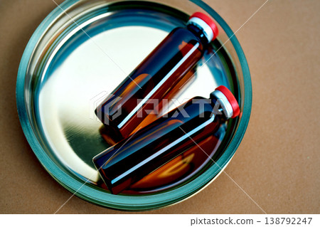 Lab vials containing medicine on a reflective tray Lab vials containing medicine on a reflective tray 138792247