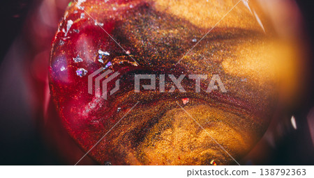 Sphere flowing paint. Golden round texture. Defocused yellow red purple color spatter glitter liquid crystal floating on abstract light background. Sphere flowing paint. Golden round texture. Defocused yellow red purple color spatter glitter liquid crystal floating on abstract light background. 138792363