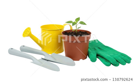 Gardening tools including a yellow watering can, green gloves, and a potted plant with soil isolated on a transparent background 138792624