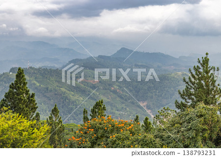 View from Ambuluwawa Tower, multi-religious temple complex located in Gampola, in Sri Lanka. Breathtaking Lush Green Mountain Landscape Under Overcast Sky in Tropical Setting View from Ambuluwawa Tower, multi-religious temple complex located in Gampola, in Sri Lanka. Breathtaking Lush Green Mountain Landscape Under Overcast Sky in Tropical Setting 138793231