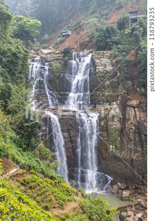 Ramboda Waterfall near Nuwara Eliya town in Sri Lanka. Majestic Multi-Tiered Waterfall Plunge Amidst Lush Green Mountainous Landscape and Rocky Outcrops Ramboda Waterfall near Nuwara Eliya town in Sri Lanka. Majestic Multi-Tiered Waterfall Plunge Amidst Lush Green Mountainous Landscape and Rocky Outcrops 138793235