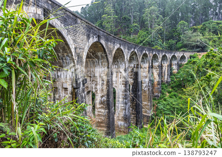Nine Arch Bridge near Ella town in Sri Lanka. Historic Stone Arch Bridge Amidst Lush Green Tropical Forest Scenery, Architectural Marvel in a Verdant Landscape 138793247