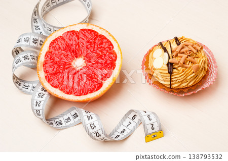 Grapefruit and cake with measuring tape. Diet Grapefruit and cake with measuring tape. Diet 138793532