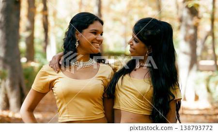 Two indian women friends smiling embracing outdoors 138793772